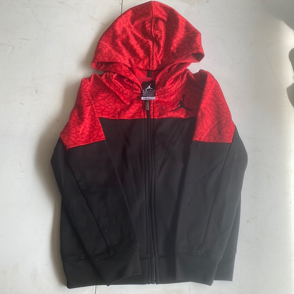 Black and red Jordan zip up sweatshirt. Lightly used. Size kids M.